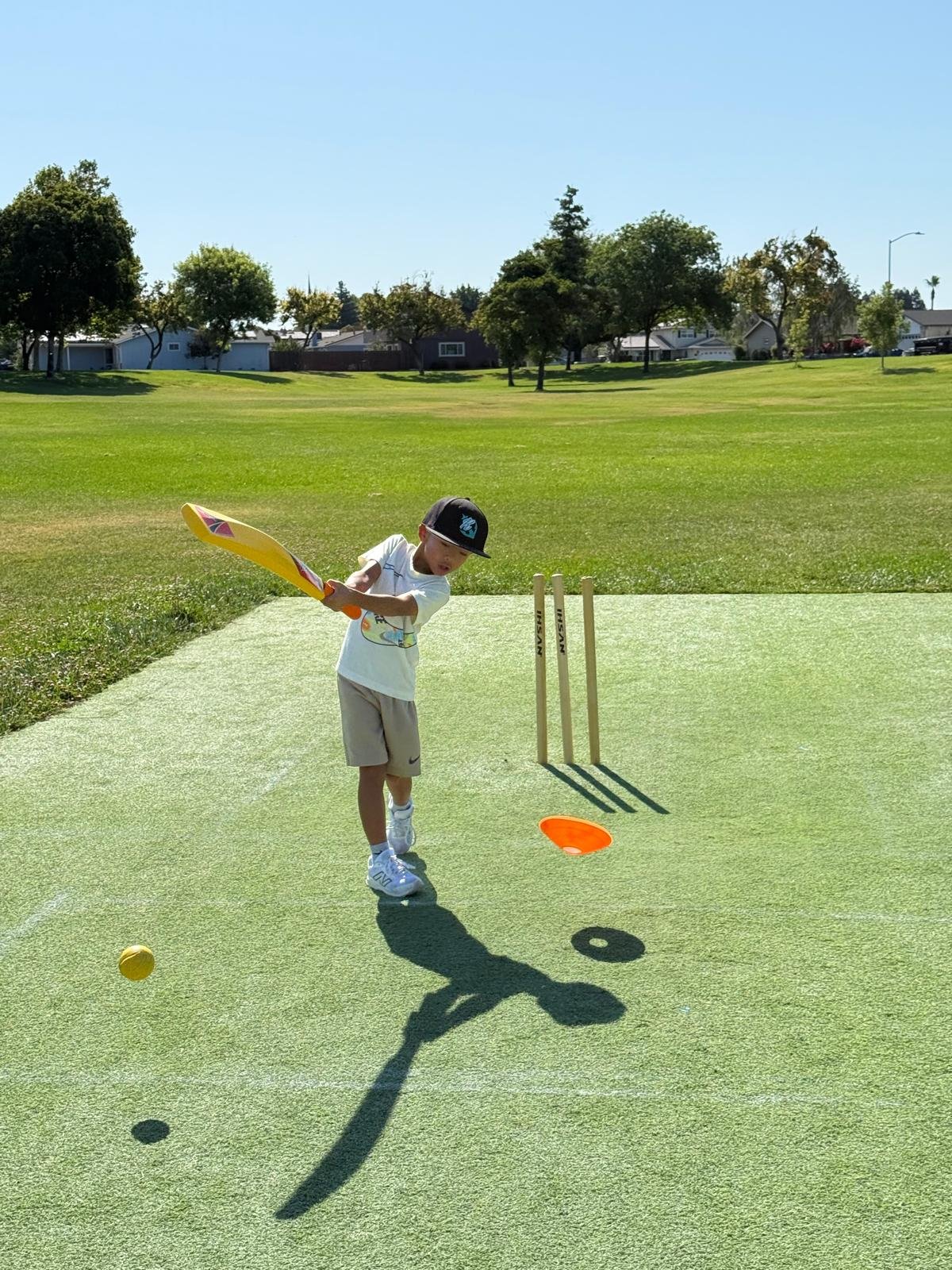 Young player batting on turf wicket in Manteca park
